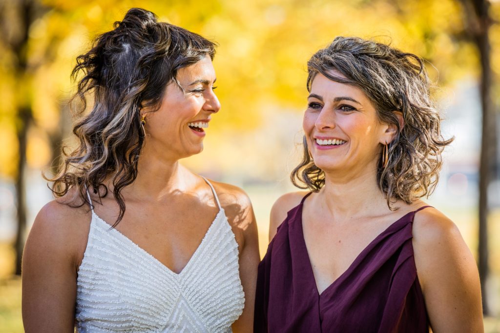 The bride and her sister laugh together