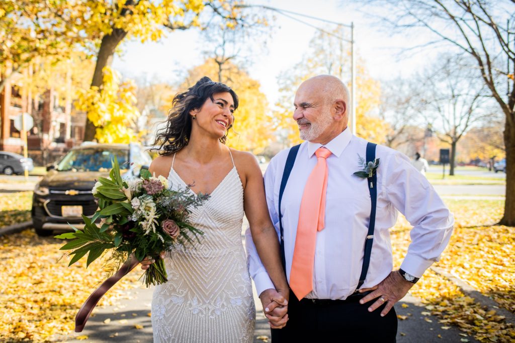 Bride laughs as her smiling father walks her down Logan Boulevard