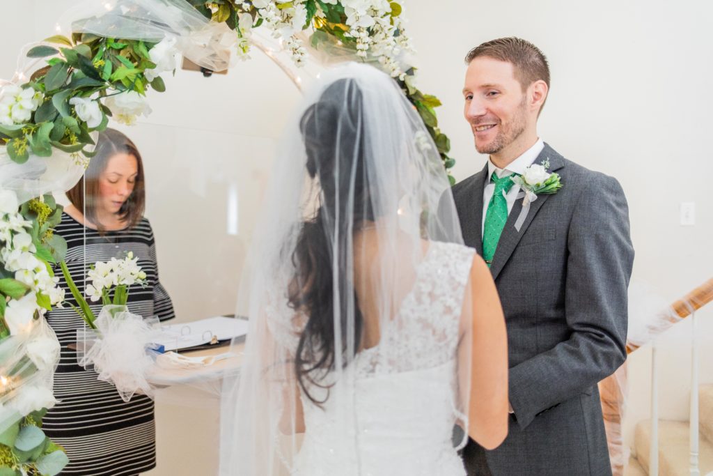 Groom looking at bride at the altar