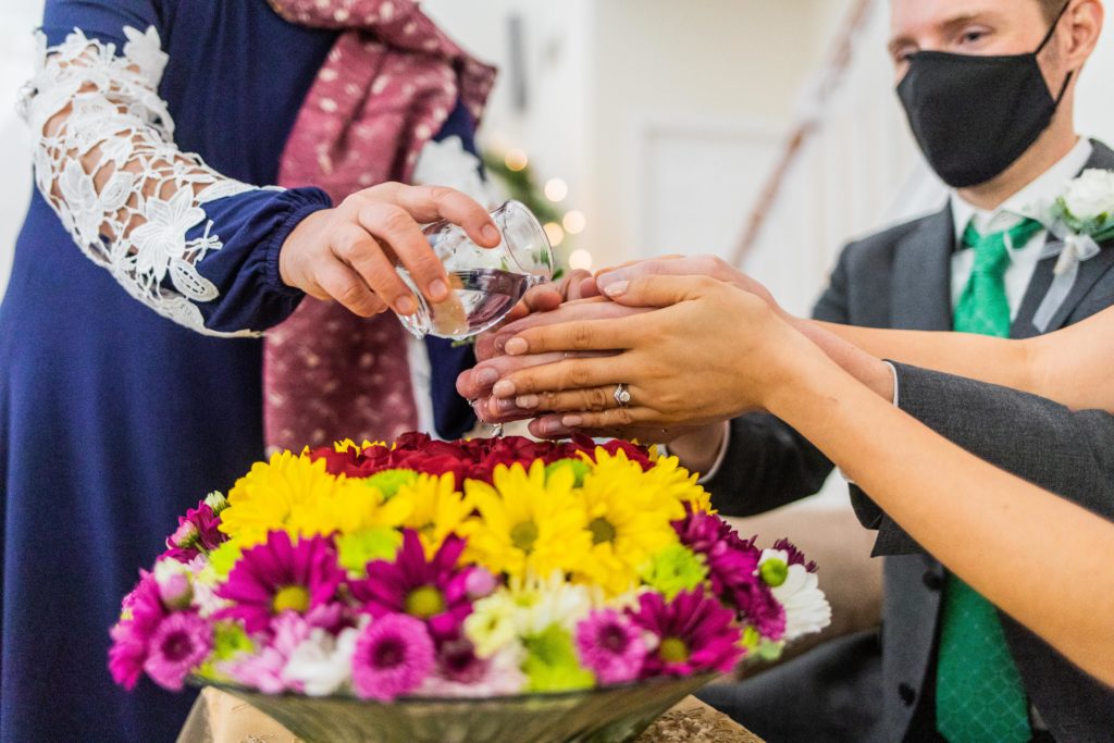 Water is poured of the hands of the bride and groom during the Thai water ceremony by the bride's mother