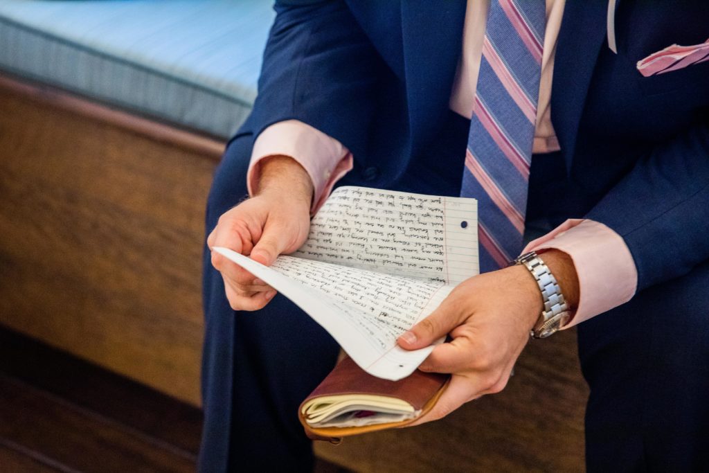 Groom holding the letter written by the bride