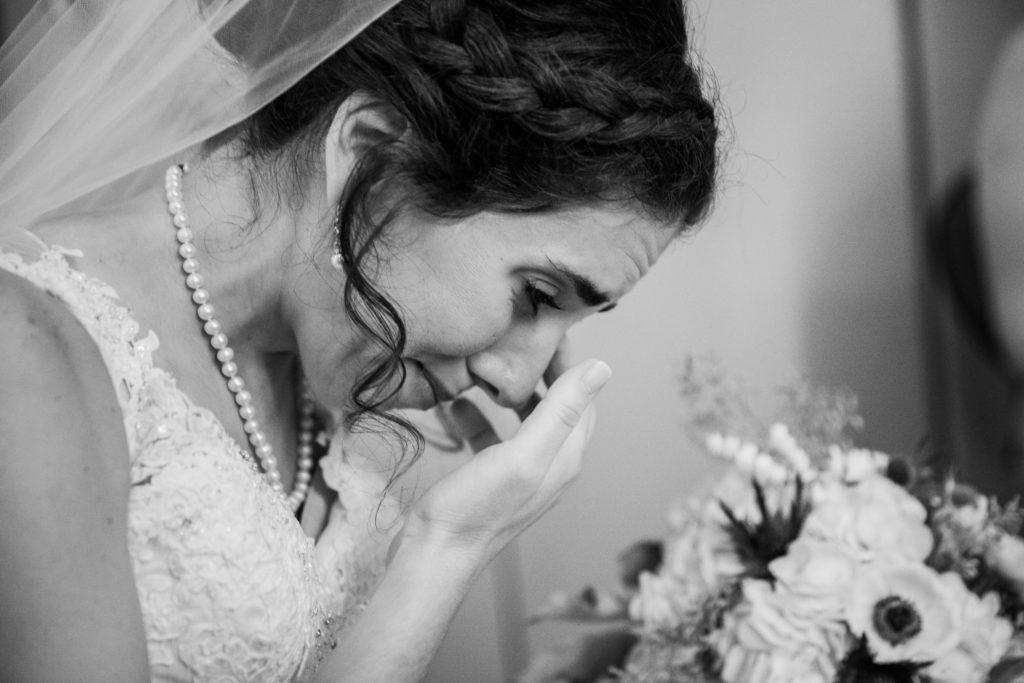 Bride crying while getting ready for the ceremony