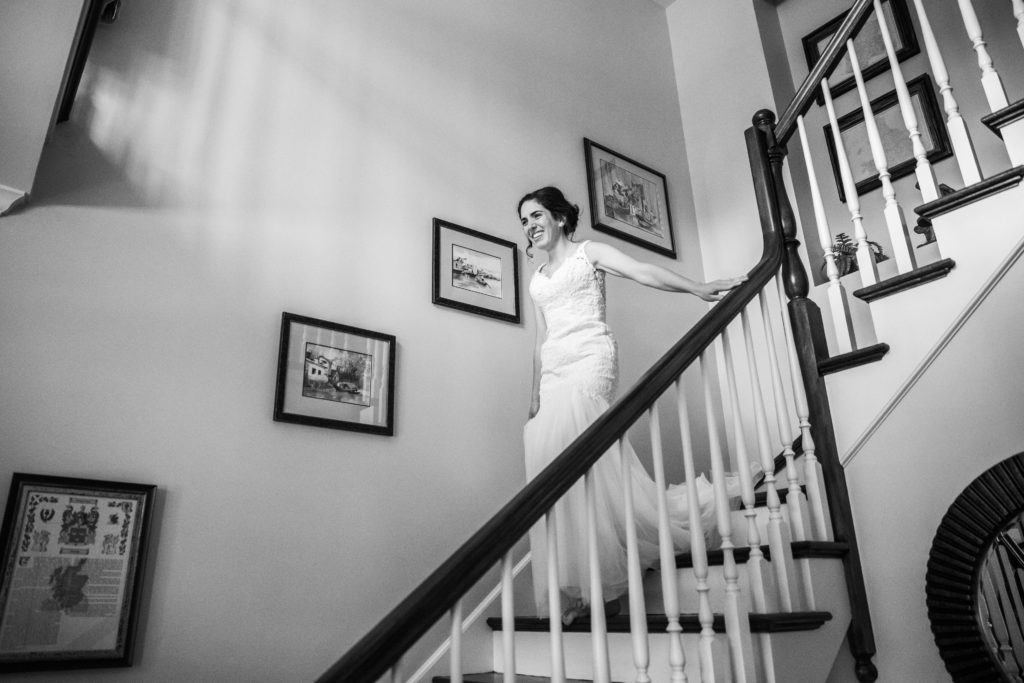 Bride smiling as she walks down the stairs