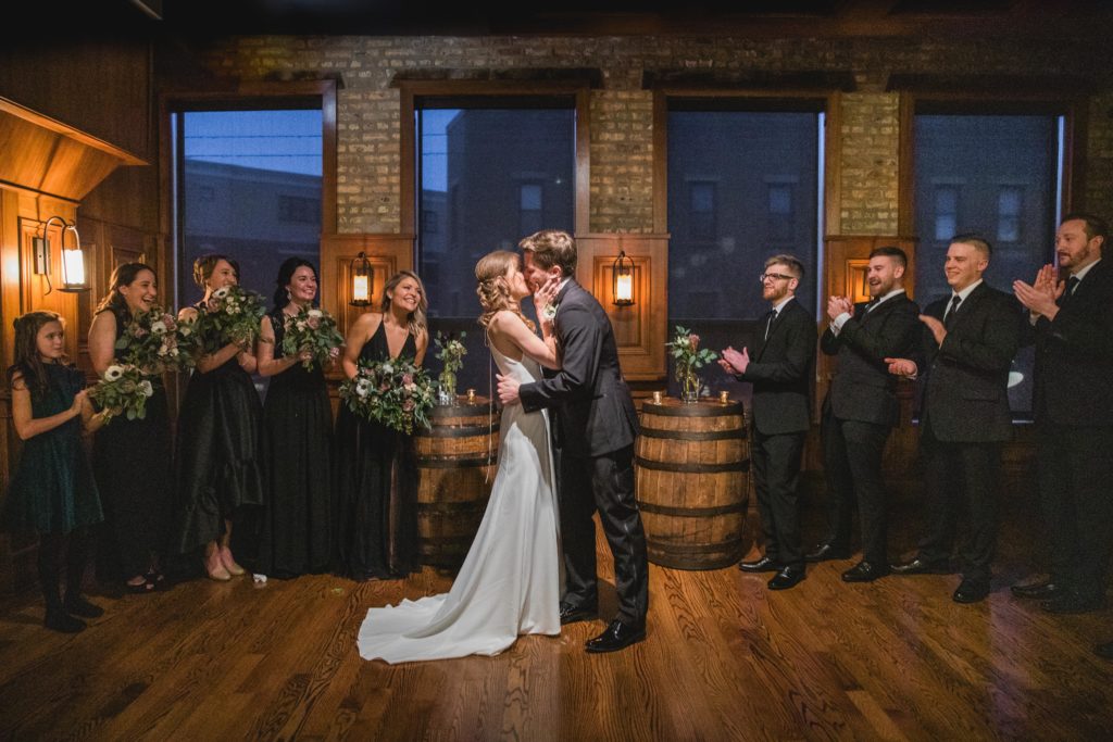 Bride and groom kiss at their Revolution Brewing Wedding