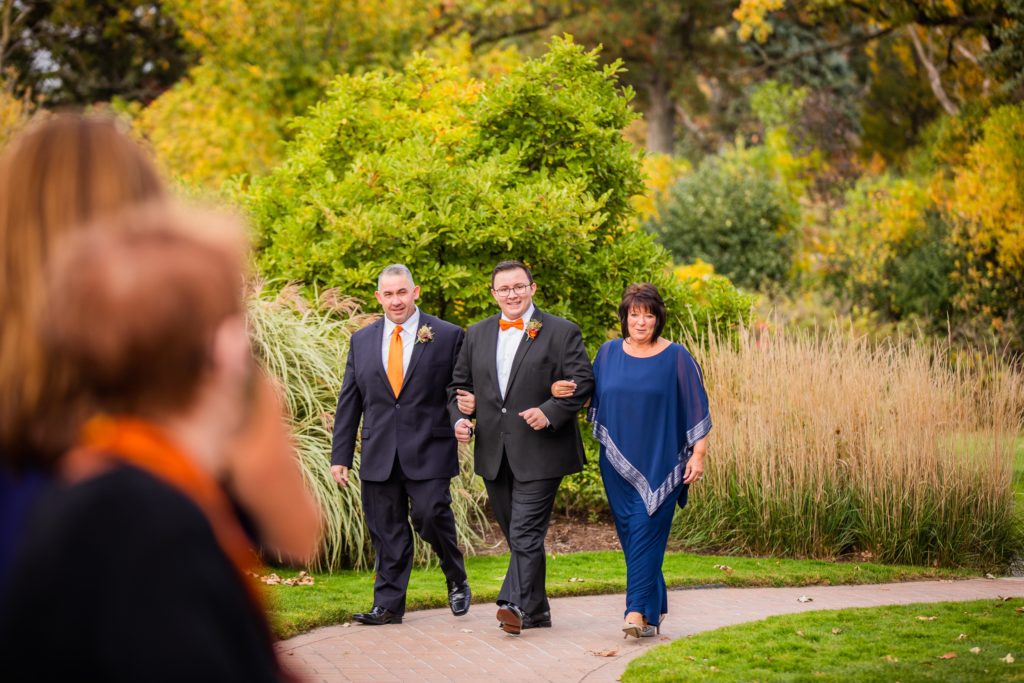 Groom gets walked down the aisle by his parents