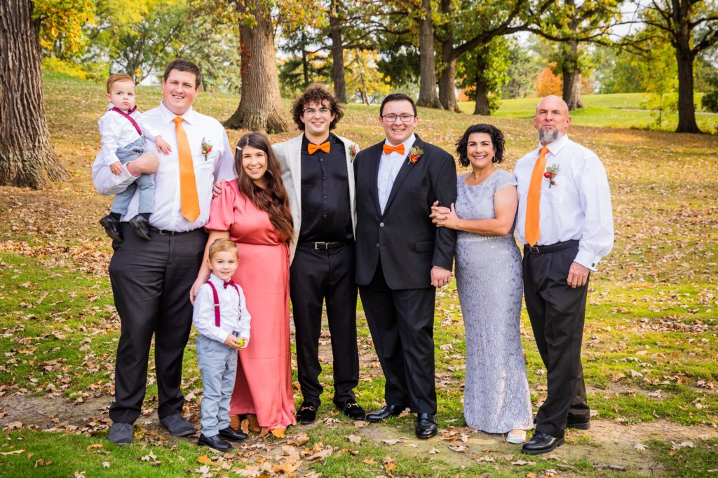Couple poses with their family for photos