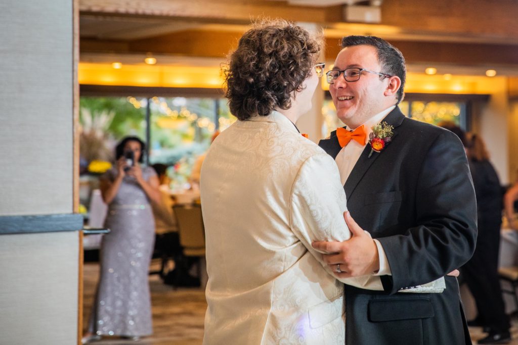 Grooms share a first dance on the dance floor