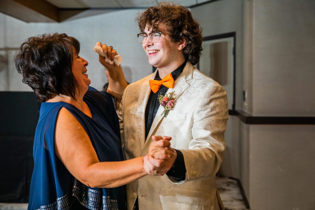 Groom laughs as he dances with his mother-in-law