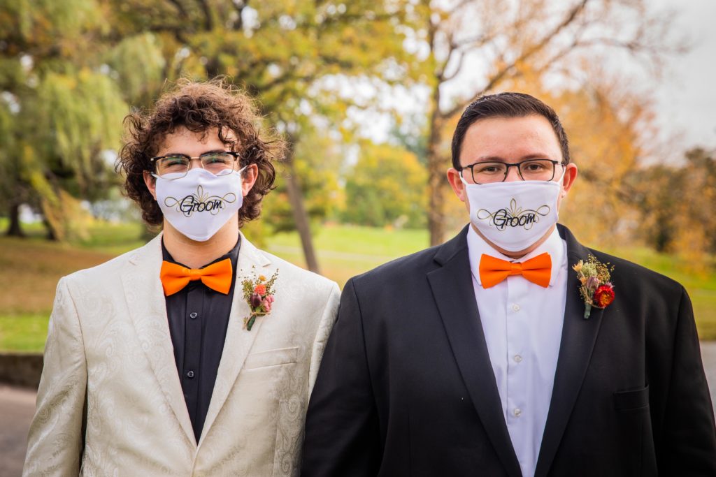 Grooms wear matching "Groom" masks at their wedding