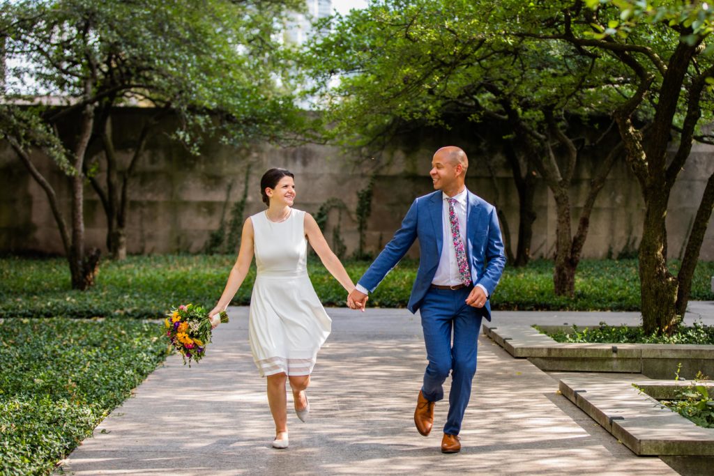 Bride and groom run while holding hands after their Chicago City Hall Wedding