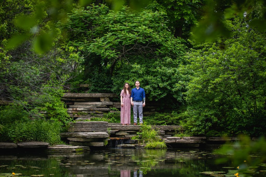 Man and woman staring out into a lily pool