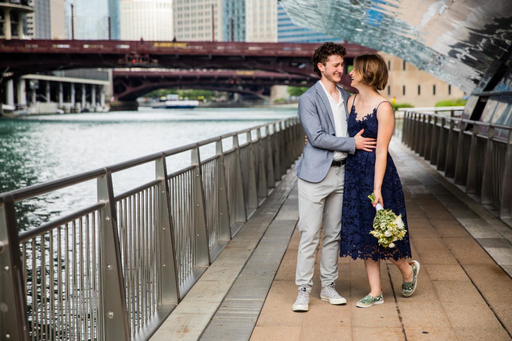 Man and woman holding each other and smiling while walking down the Chicago Riverwalk