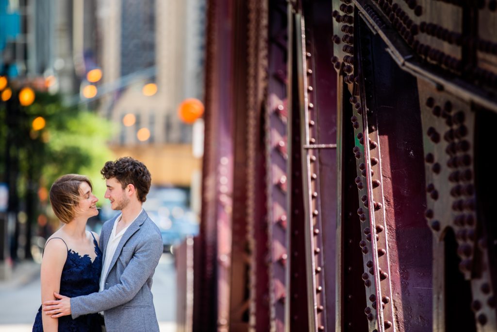 Bride and groom laughing while on a bridge in Chicago