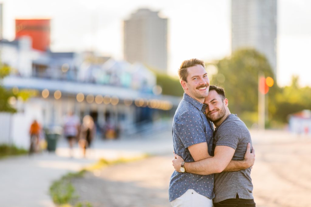 Men embracing each other and smiling at North Avenue Beach