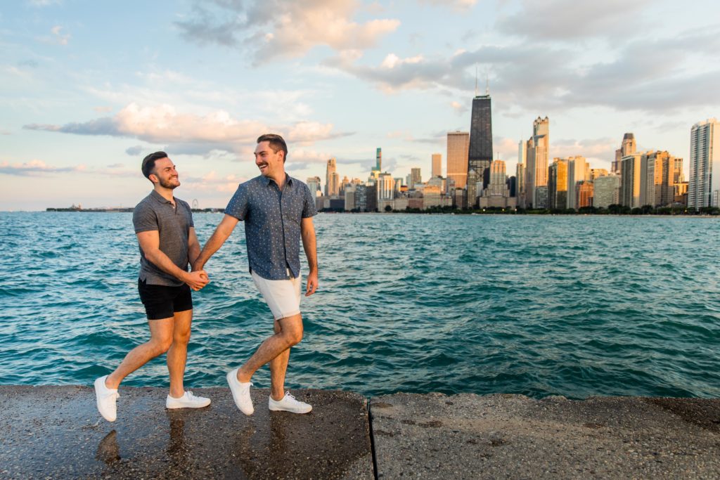 Men holding hand in hand while looking back near the water at North Avenue Beach