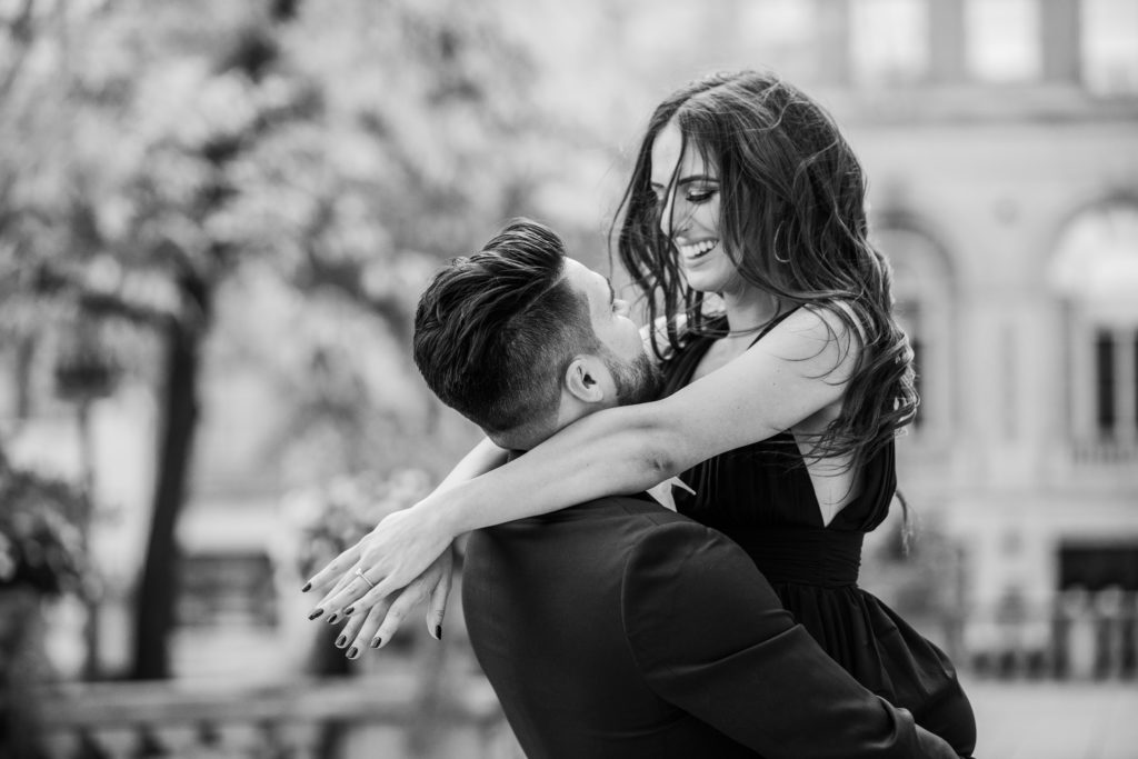 Woman smiling whole spinning in her man's arms