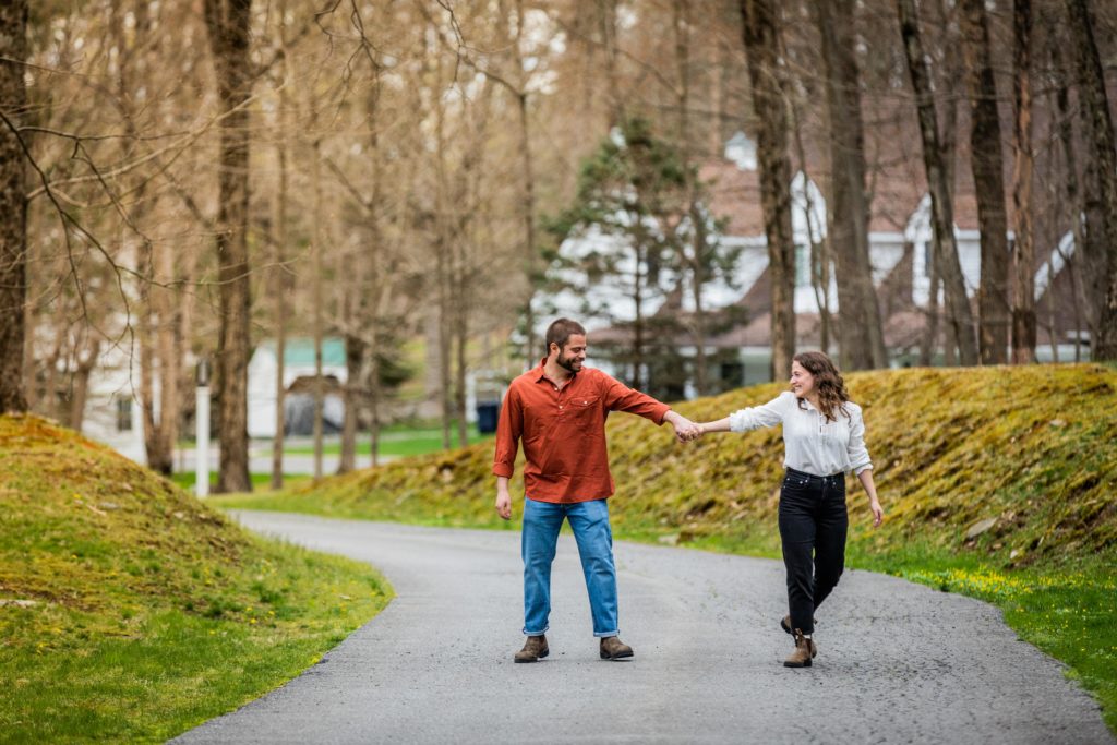 Couple dancing on the road during their engagement session in Bedford