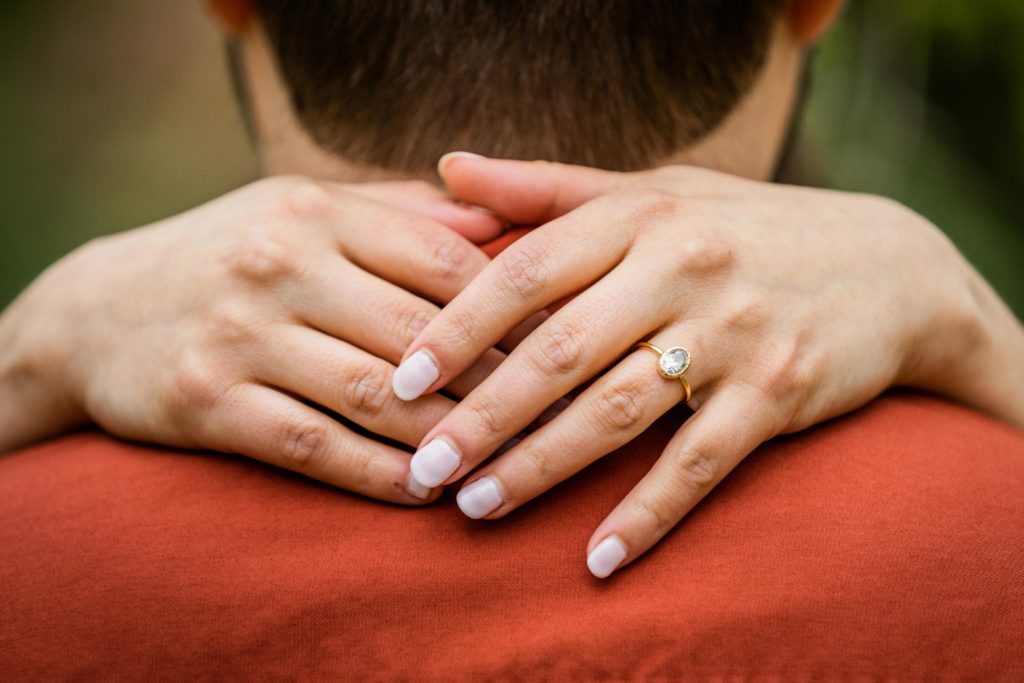 Close up of a woman's hands with her ring during their engagement session in Bedford