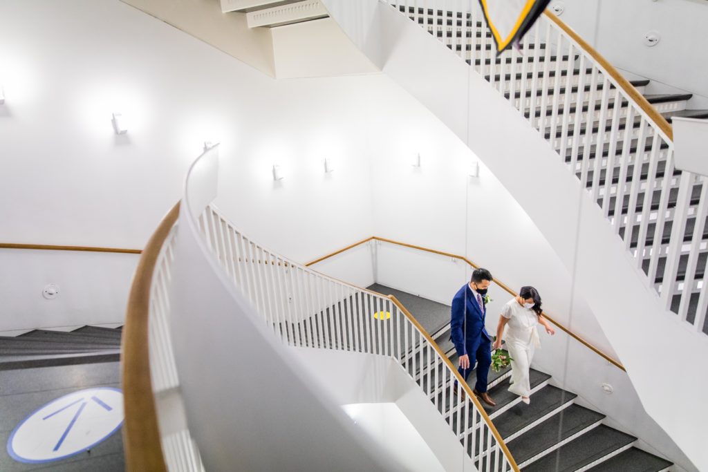Bride and groom walk down the staircase in the MCA Chicago