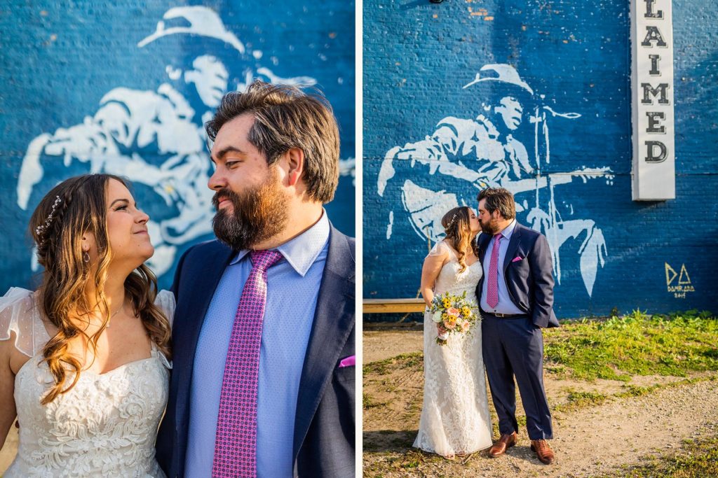 Bride and groom pose in front of Reclaimed Bar and Restaurant