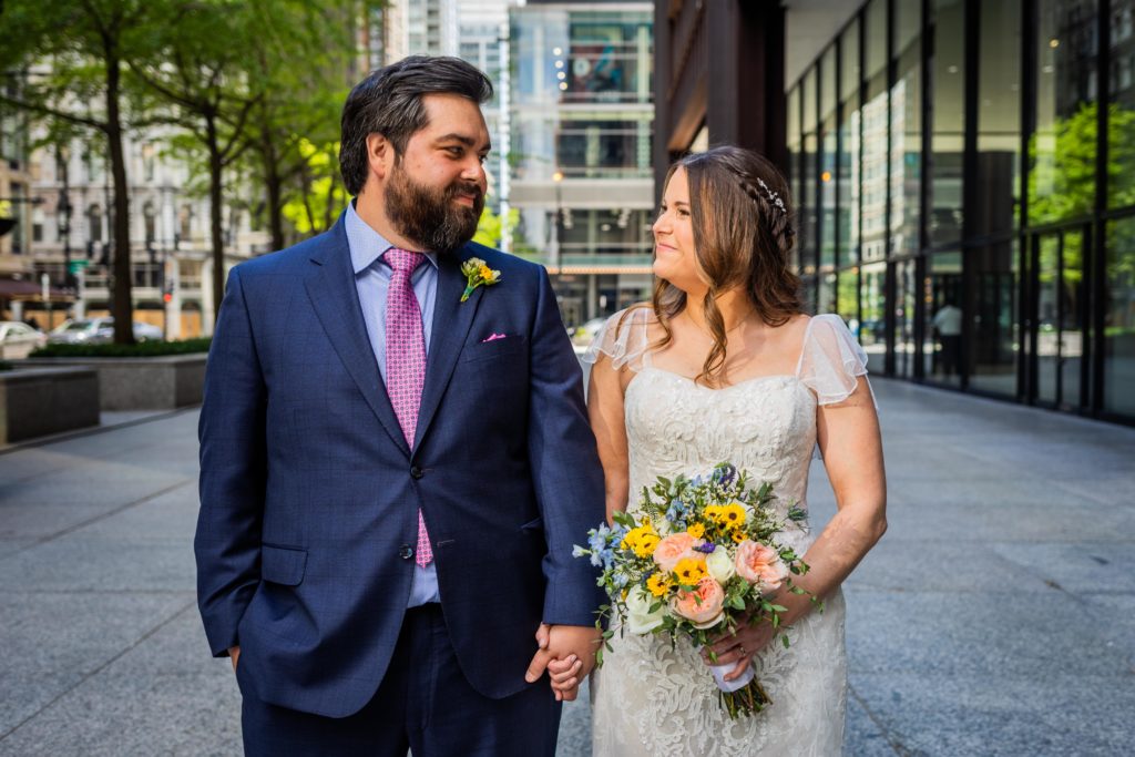 Bride and groom smiling at each other at Chicago City Hall