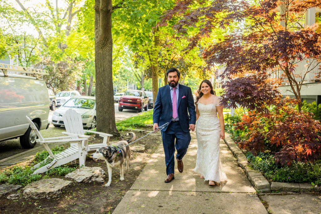 Bride and groom walking their dog before they go to their Reclaimed Bar and Restaurant Wedding reception