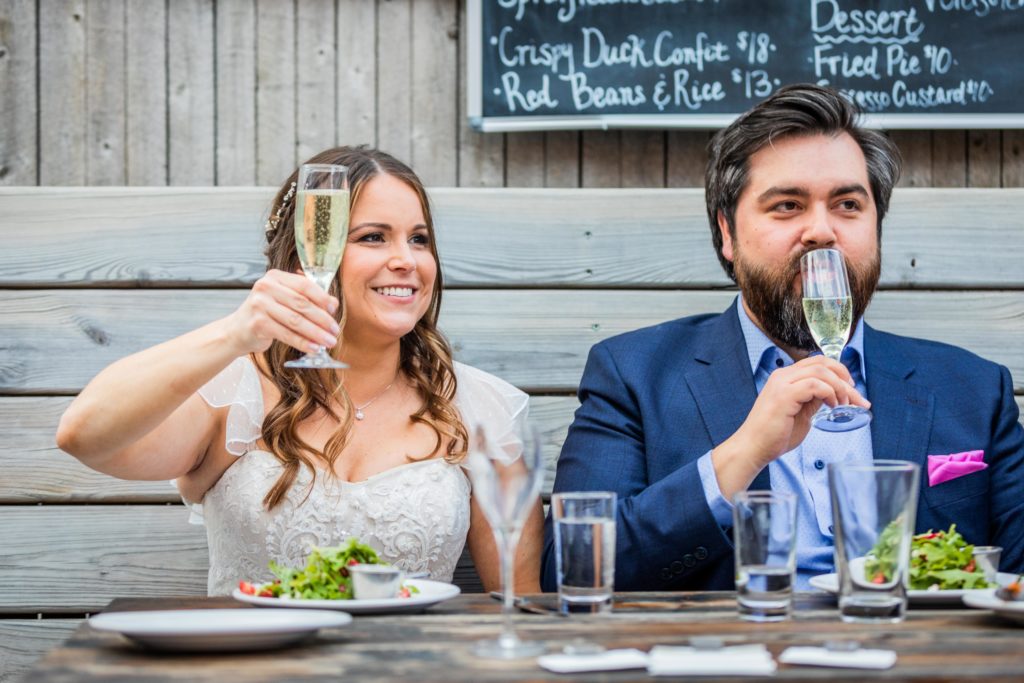 Bride and groom drinking champagne