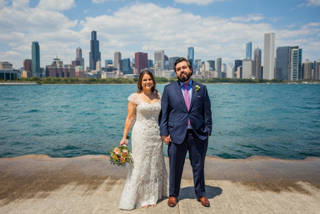 Couple smile with the Chicago skyline in the background