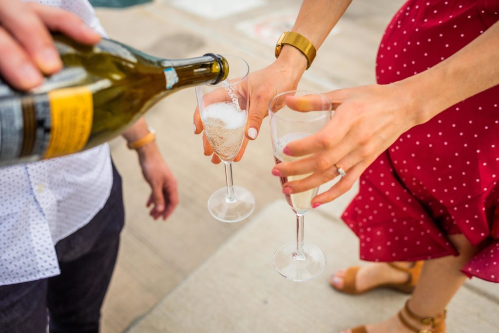 Couple pours champagne into glasses