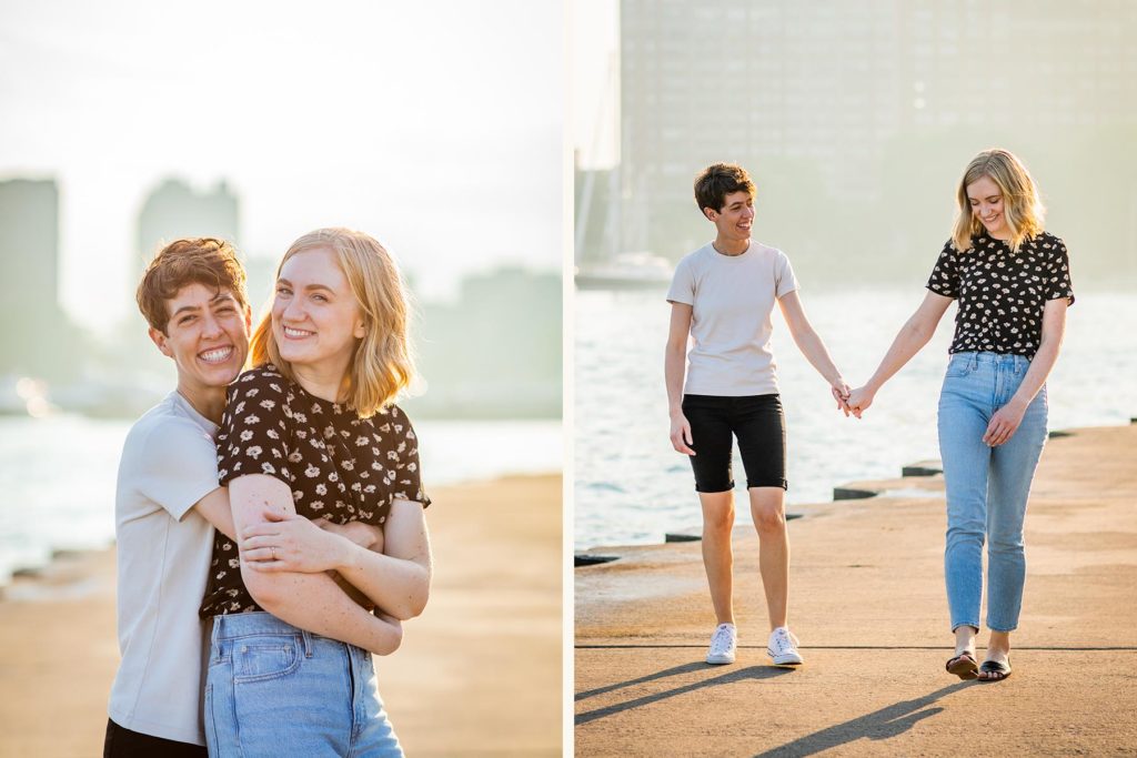 Couple smiling wide and holding hands at golden hour during their engagement session at belmont harbor