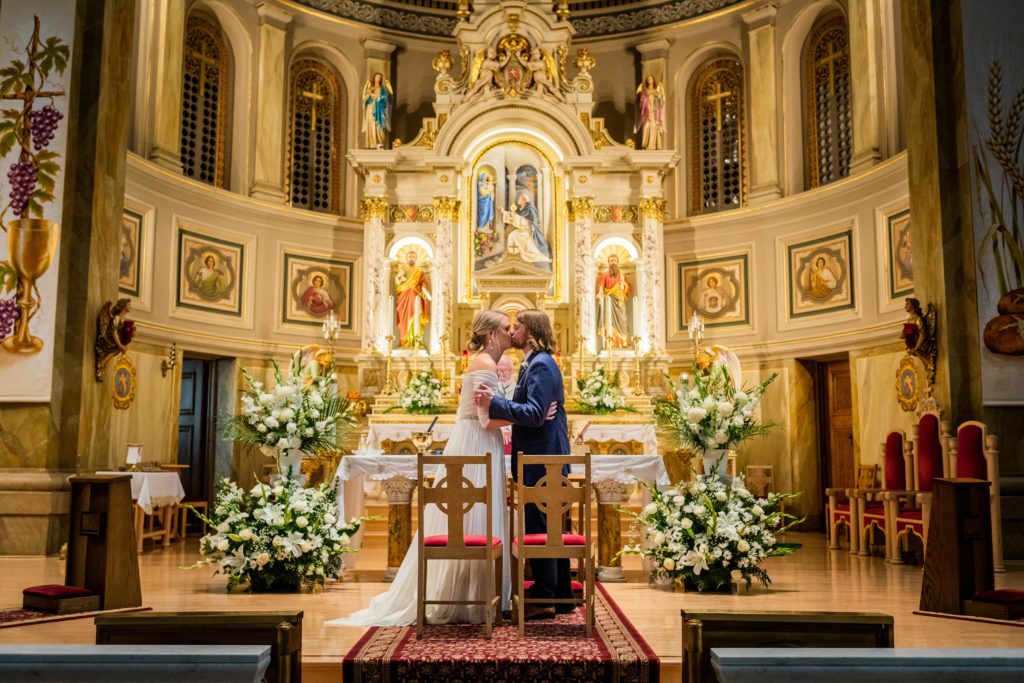 Bride and groom hold each other and kiss at St. Hyacinth Basilica
