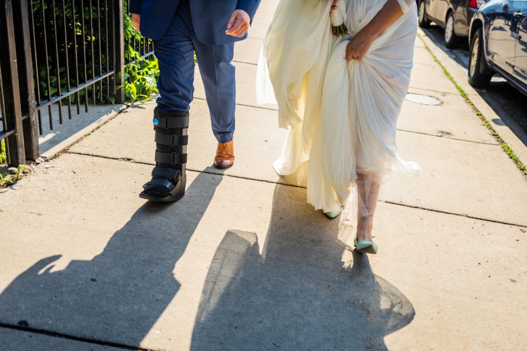 Bride and groom walk to the bus to go to their Big Star Reception