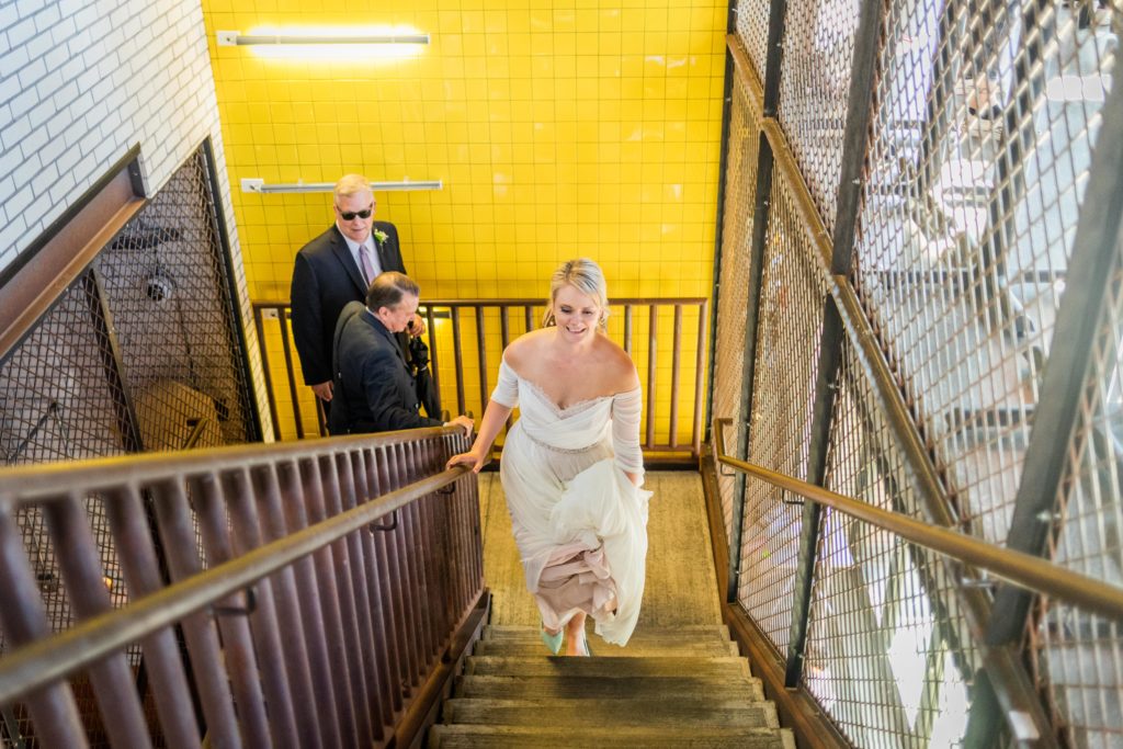 Bride walking up the stairs at her Big Star reception