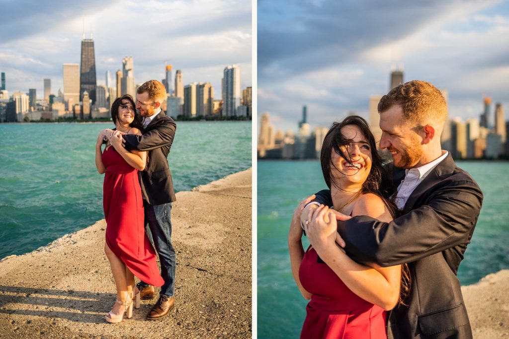Man holding woman from behind while they smile at each other during their North Ave Beach Engagement Session