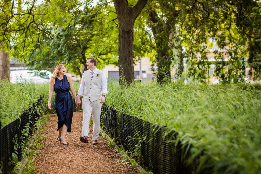Bride and groom walking in Welles Park