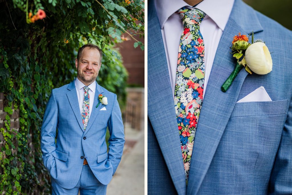 Groom posing for a photo in his State and Liberty suit with boutonniere 