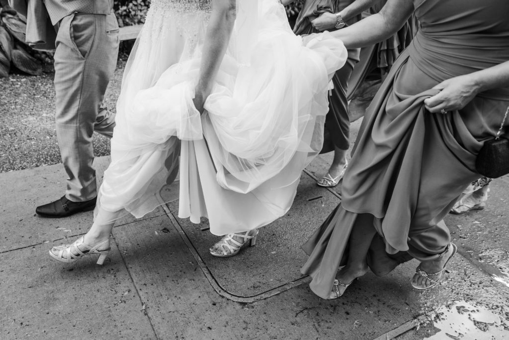 Bride walking and holding her dress