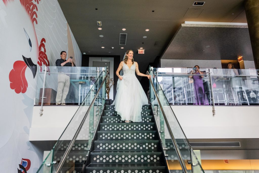 Bride walking down the stairs to meet the groom
