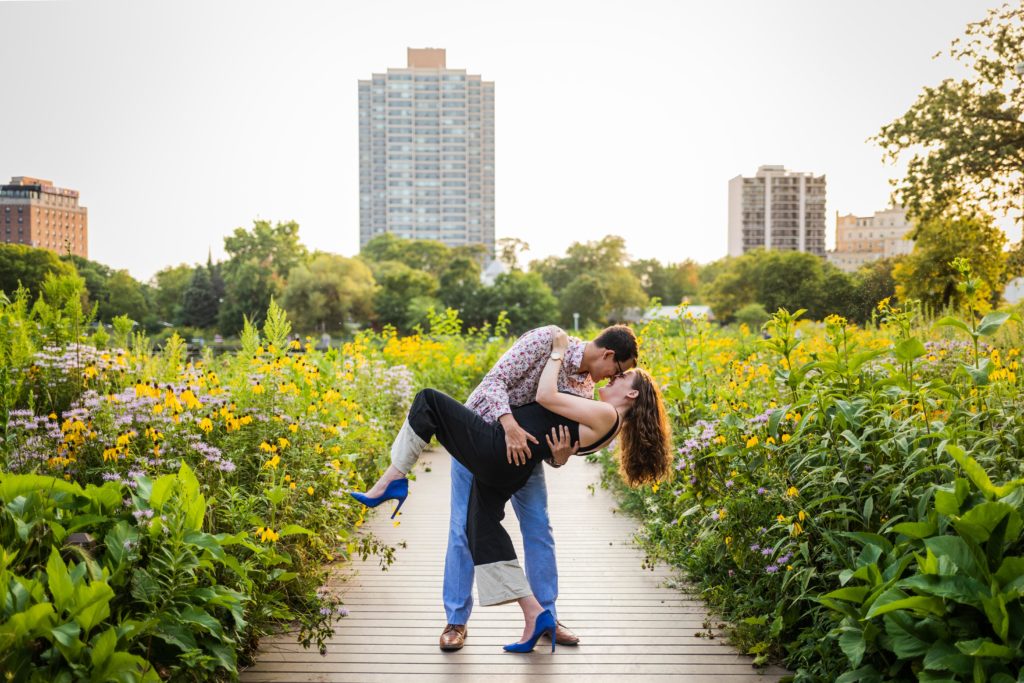 Man dipping woman during their south pond engagement session