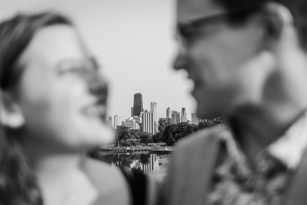 Couple looking at each other with the Chicago skyline in the background