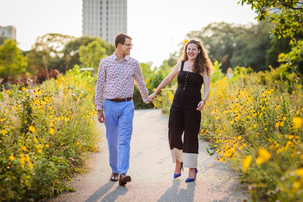 Couple laughing and walking in the sunshine during their south pond engagement session