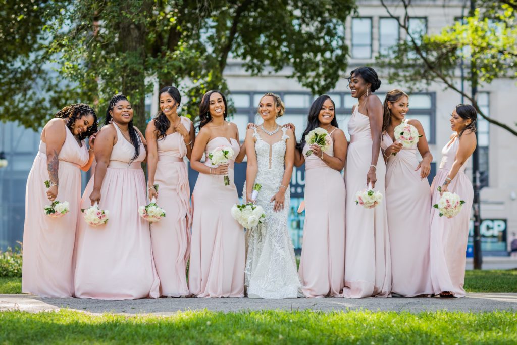 Bridesmaids laughing with the bride in front of Venue SIX10