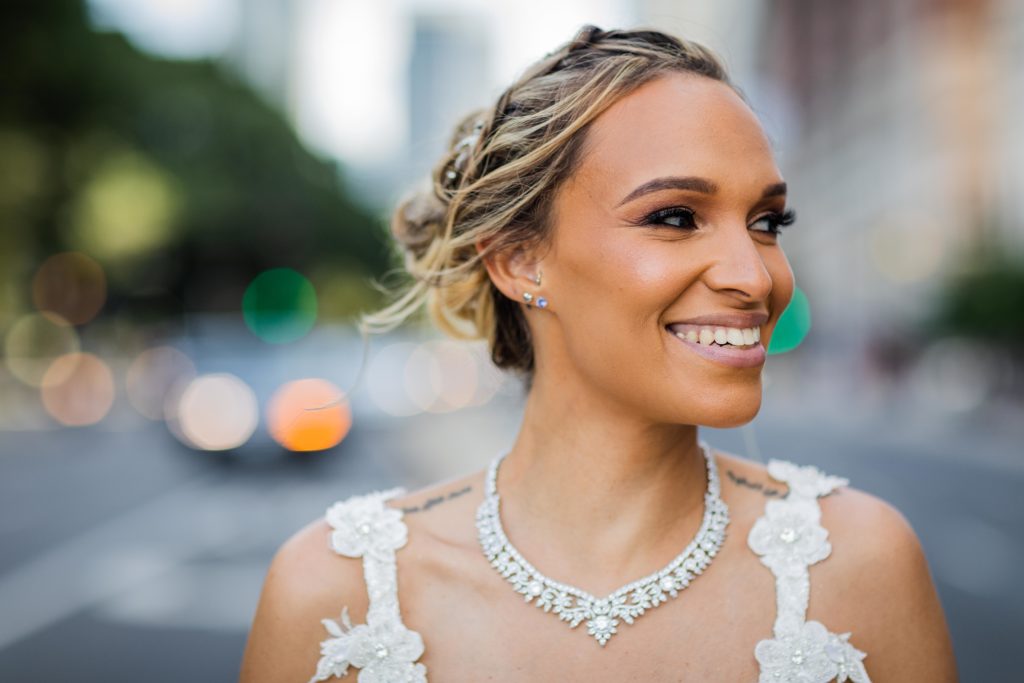 Bride smiling while standing in the middle of the street in Chicago