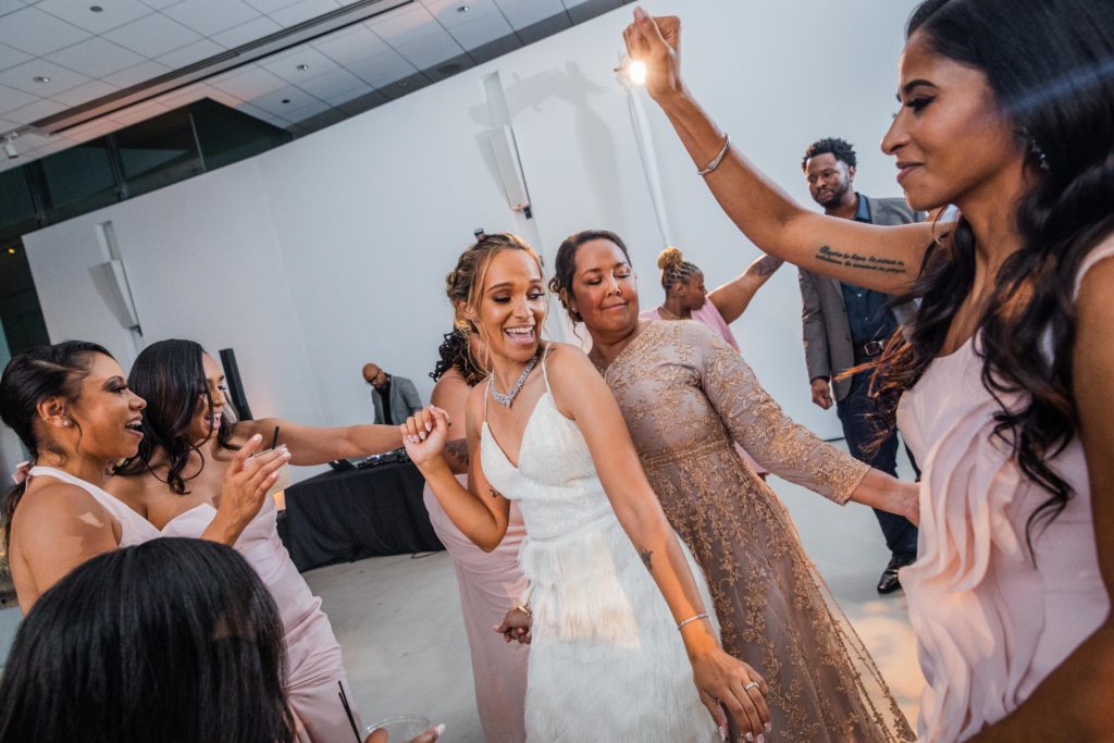 Bride dancing back to back with her mom