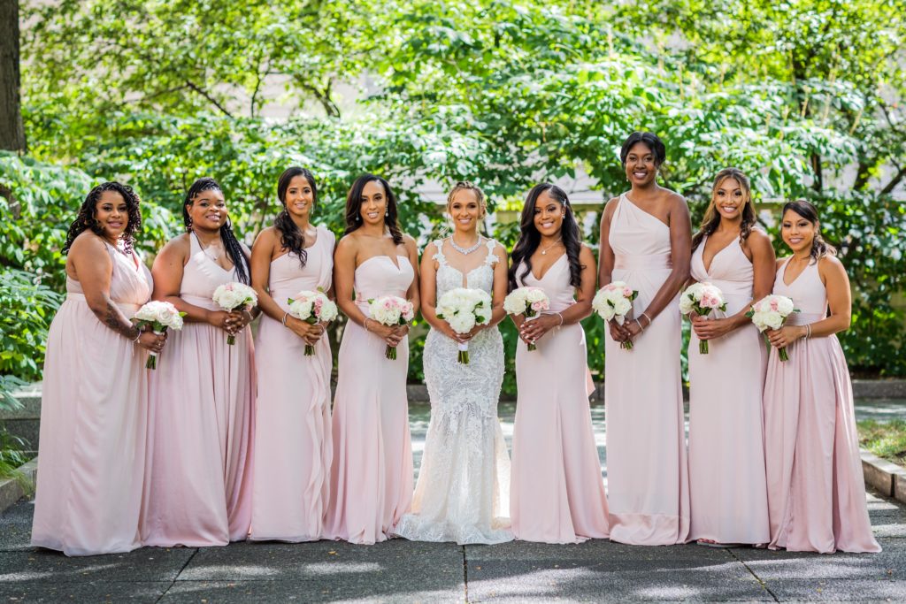 Bridesmaids posing for a photo in the Art Institute Gardens before the wedding at Venue SIX10