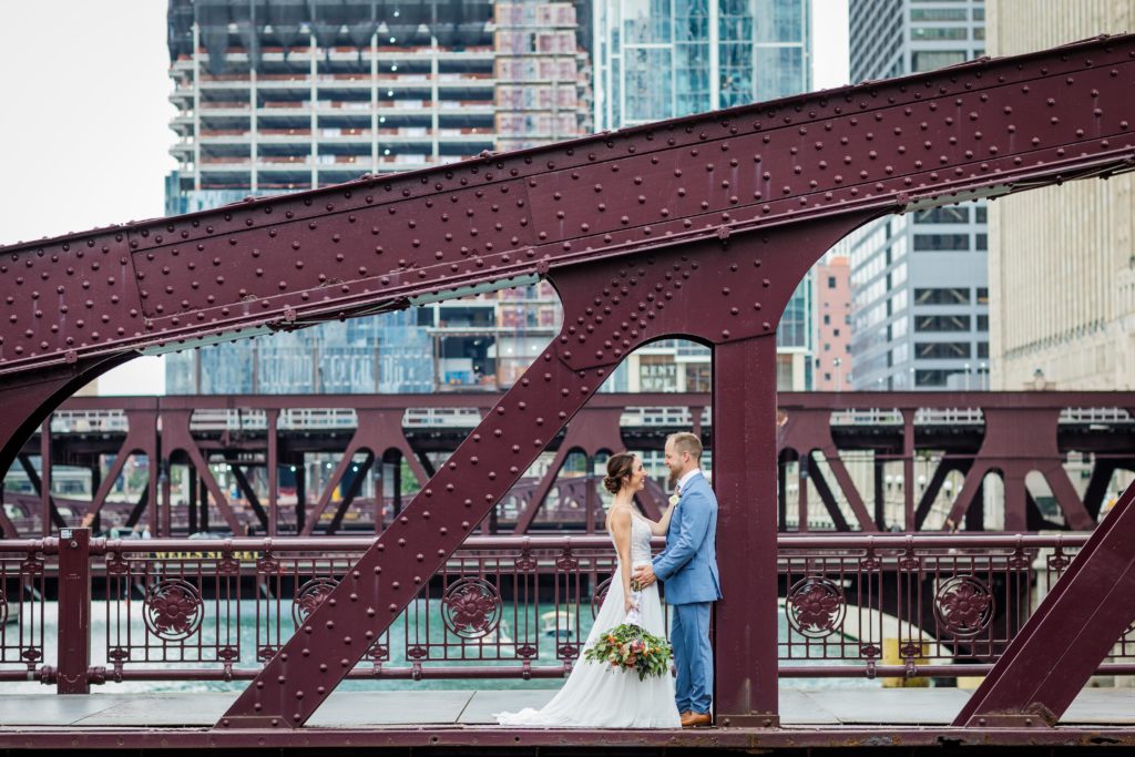 Couple looking at each other on the Lasalle Street bridge in downtown Chicago