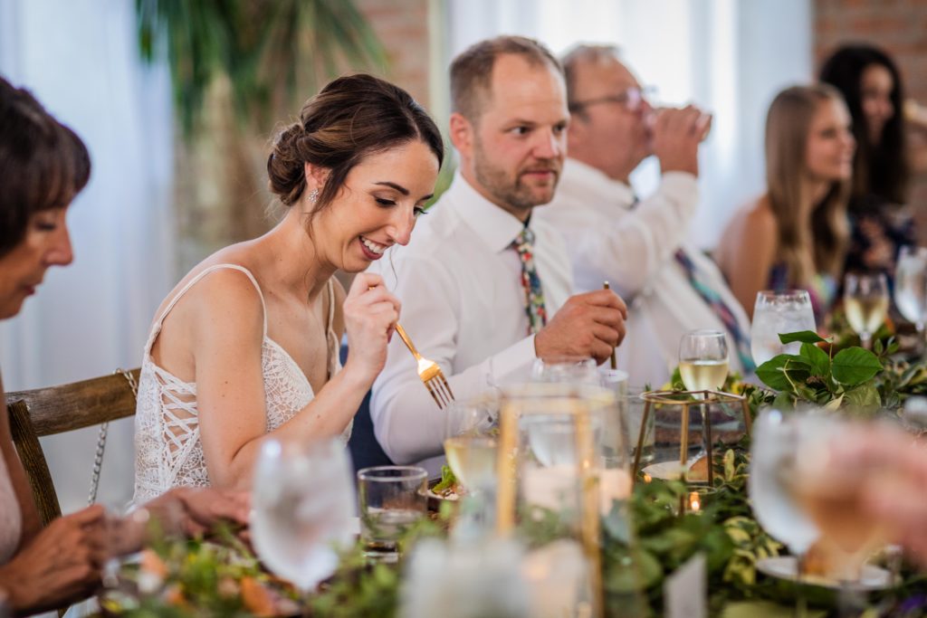 Bride takes a bite out of her salad at Big Delicious Planet