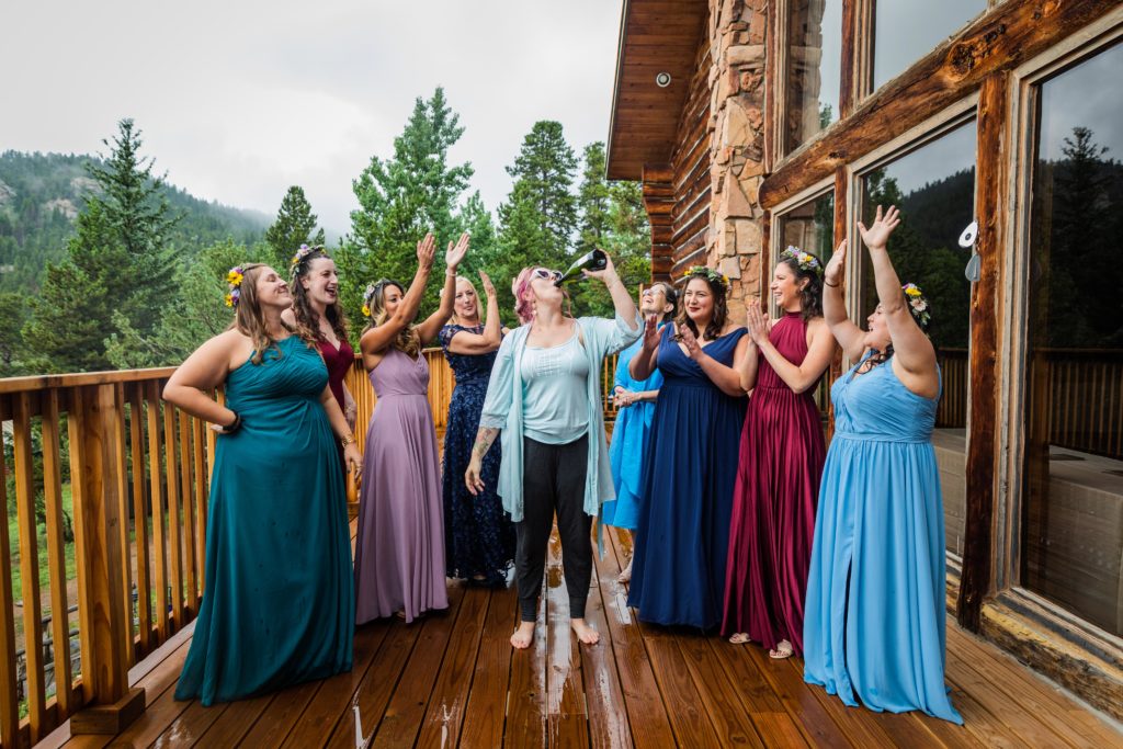 Bride drinking champagne with her bridesmaids at the Dao House in Estes Park