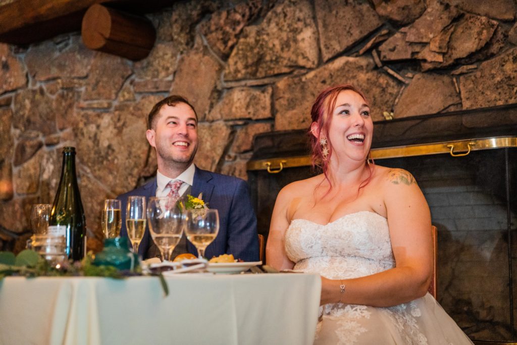 Newlyweds laughing during a speech