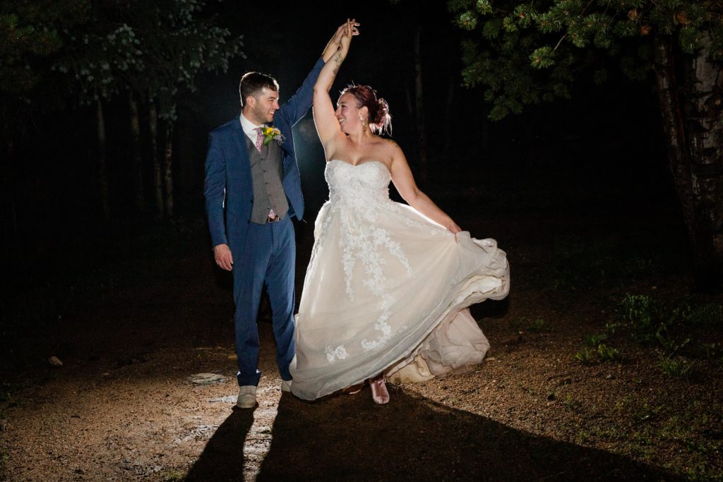 Groom spins bride during a night portrait